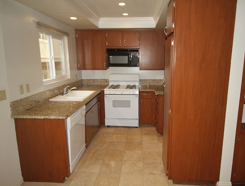 Remodeled kitchen with imported granite counters and Travertine floor