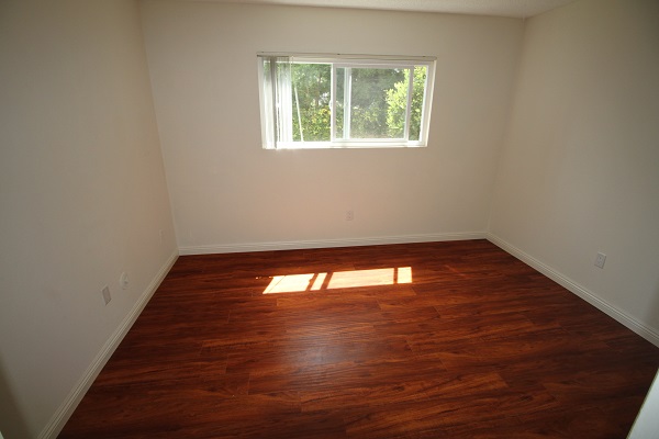 Third bedroom on first level with hardwood floor