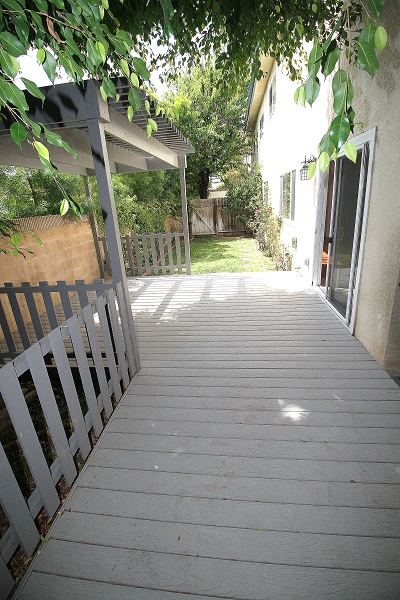 Huge backyard with large dexk and grass area