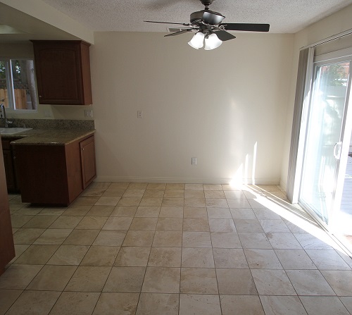 Dining room with Travertine Marble floor opening to large backyard