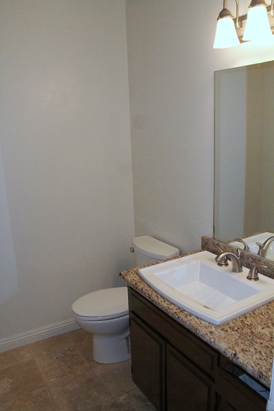 Powder Room on First Floor with Granite Counter and Travertine marble Floor
